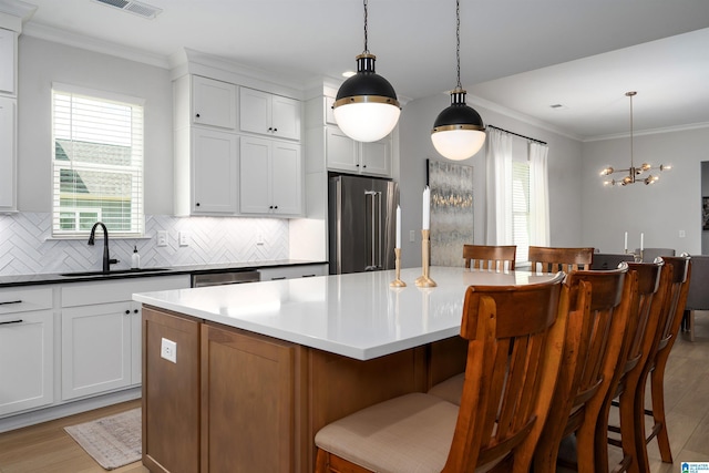 kitchen featuring tasteful backsplash, light wood-style flooring, a wealth of natural light, and stainless steel appliances
