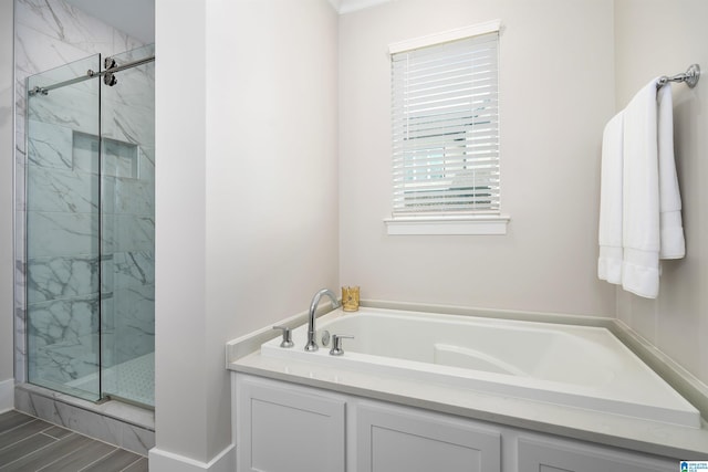 full bath with a bath, baseboards, and a marble finish shower