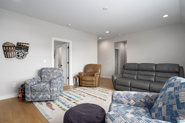 living area featuring recessed lighting, baseboards, and wood finished floors