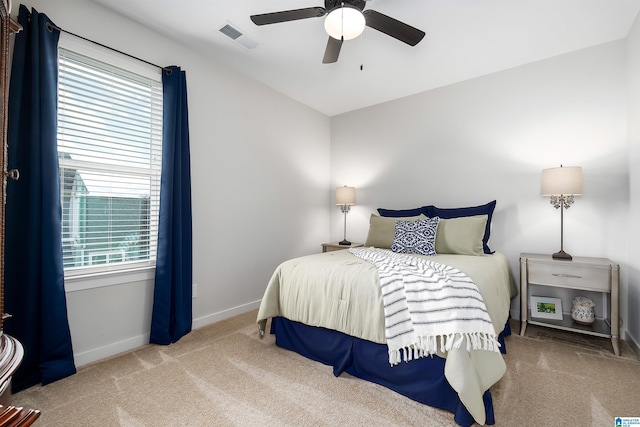 bedroom featuring ceiling fan, visible vents, baseboards, and carpet floors
