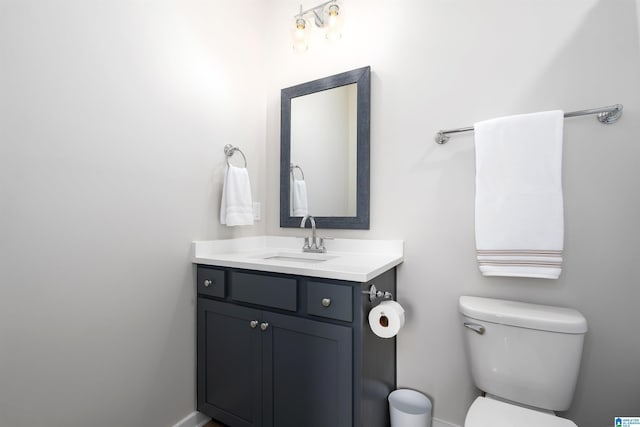 bathroom featuring toilet and vanity