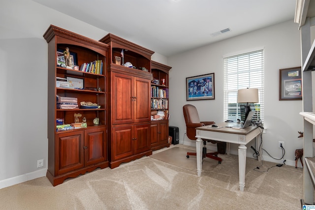 carpeted office featuring visible vents and baseboards