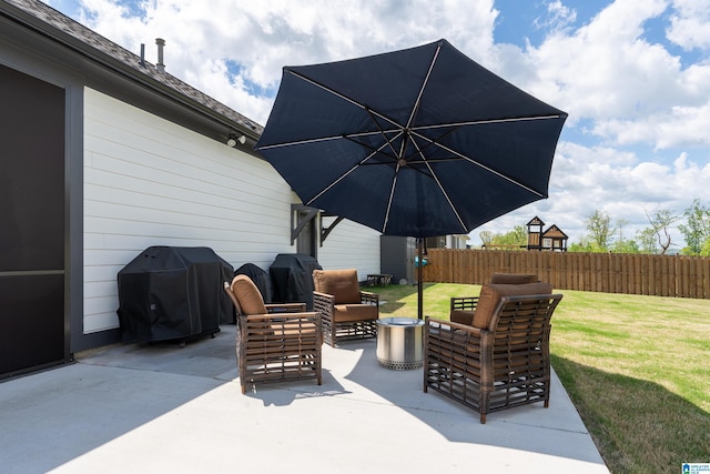 view of patio with a grill, an outdoor living space, and fence
