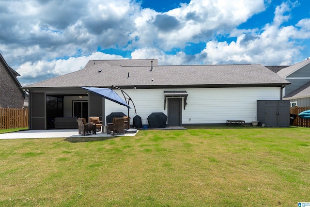 rear view of house featuring a patio area, a storage shed, fence, and a lawn
