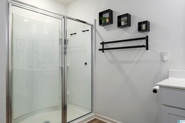full bath with a shower stall and vanity