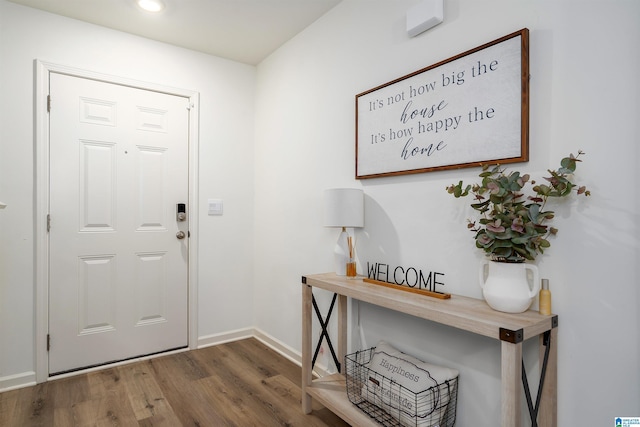 entryway with wood finished floors, baseboards, and recessed lighting
