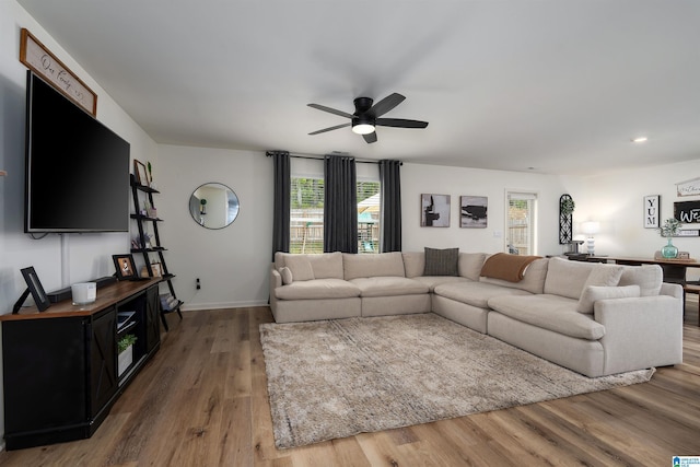 living area with recessed lighting, plenty of natural light, wood finished floors, and ceiling fan