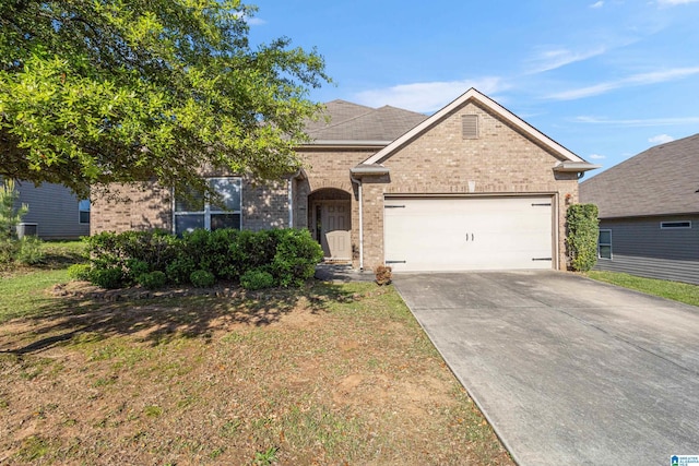 view of front of house featuring brick siding, an attached garage, and driveway