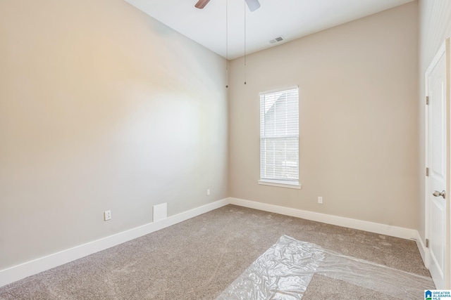 spare room featuring ceiling fan, visible vents, baseboards, and carpet floors
