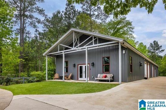 back of house with a lawn, french doors, and a garage