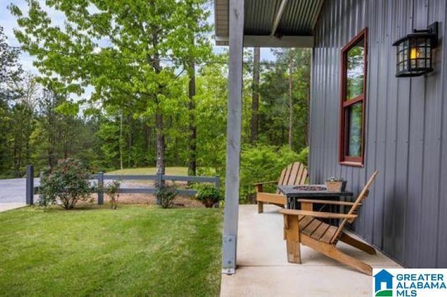 view of yard featuring a fire pit and fence