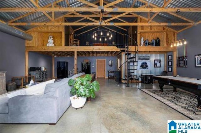 interior space with high vaulted ceiling, concrete flooring, a notable chandelier, and beamed ceiling
