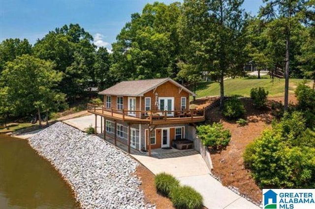 rear view of property with a patio and a deck
