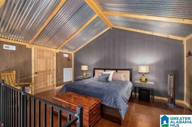 bedroom featuring lofted ceiling and visible vents