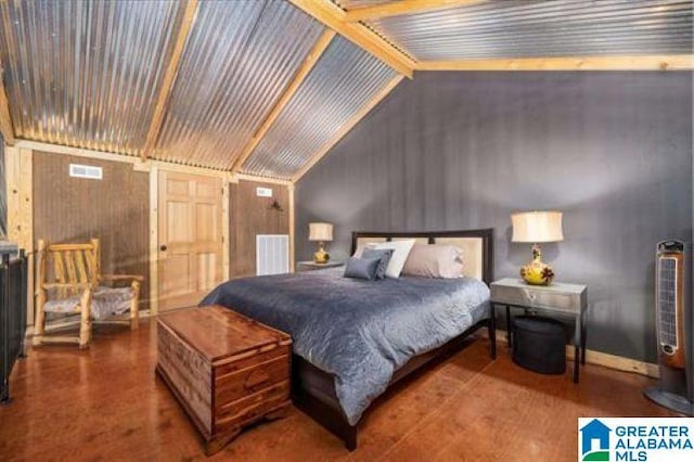 bedroom with lofted ceiling, wood finished floors, and visible vents