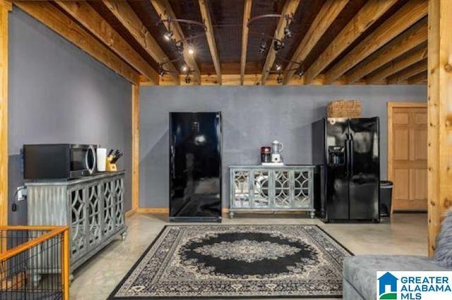 living room featuring track lighting and concrete flooring