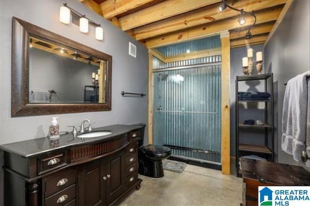 bathroom featuring concrete floors, visible vents, vanity, and beamed ceiling