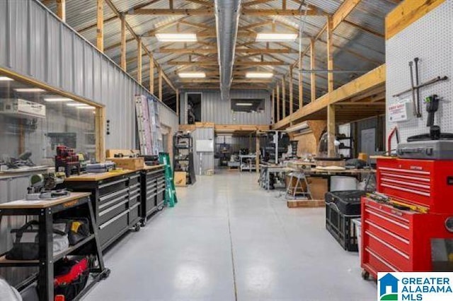 miscellaneous room with concrete floors and a workshop area