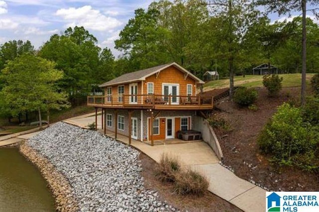 rear view of house featuring a patio area, french doors, and a deck