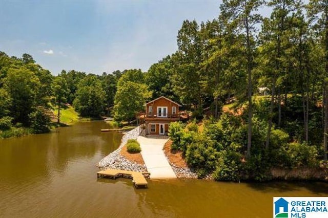 exterior space featuring a view of trees and a water view