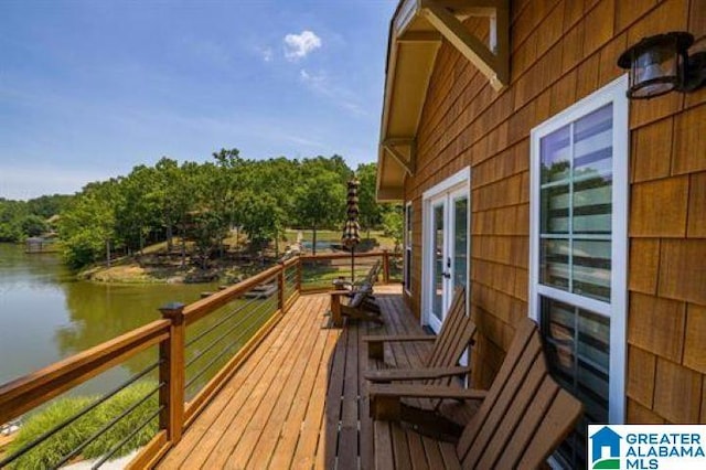 wooden deck with french doors and a water view