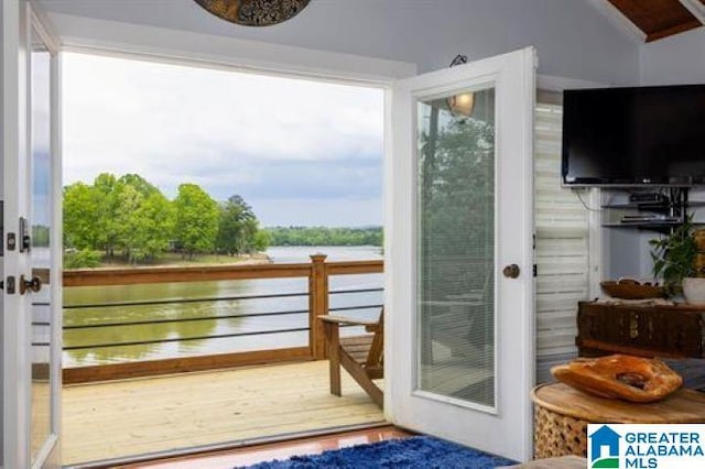 doorway to outside with vaulted ceiling and wood finished floors