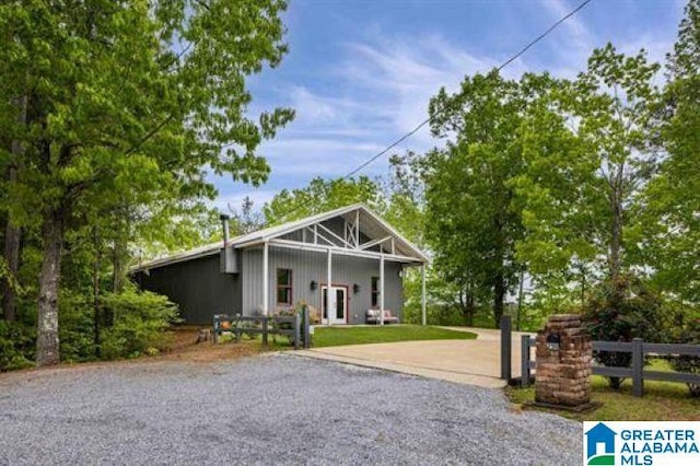 view of front of home featuring a front lawn, driveway, and fence