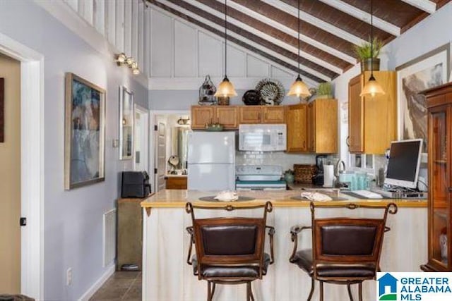 kitchen with a peninsula, vaulted ceiling with beams, white appliances, light countertops, and decorative light fixtures