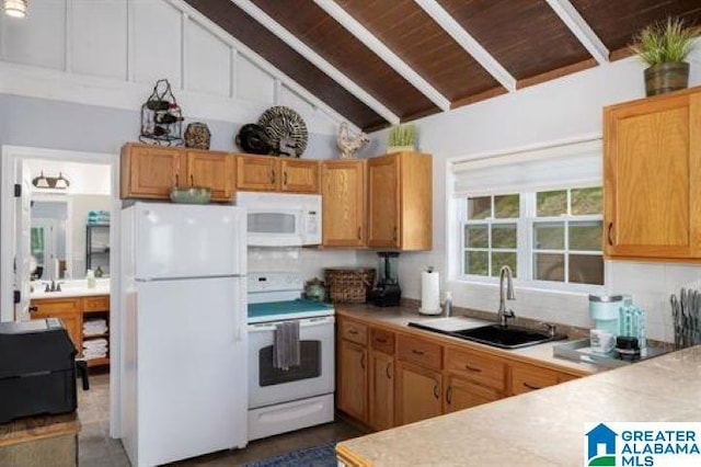 kitchen featuring vaulted ceiling with beams, a sink, white appliances, and light countertops