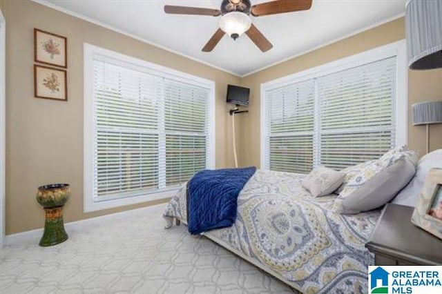 bedroom with ceiling fan and ornamental molding