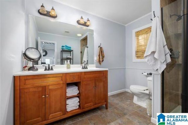 full bathroom with a sink, double vanity, toilet, a shower stall, and crown molding