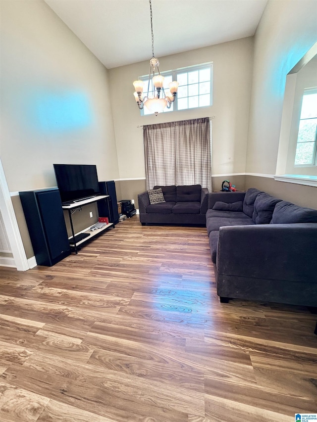 living room with an inviting chandelier and wood finished floors