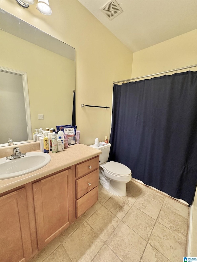 bathroom featuring visible vents, toilet, tile patterned flooring, and vanity