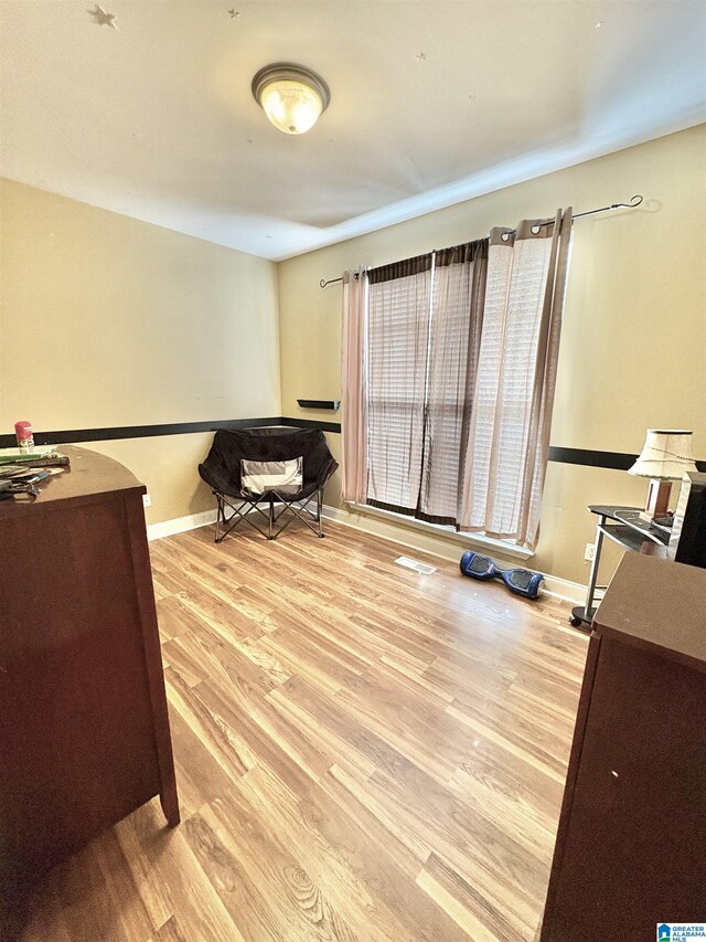 office featuring baseboards and wood finished floors