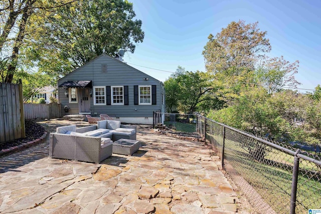 rear view of property featuring crawl space, a patio, outdoor lounge area, and a fenced backyard