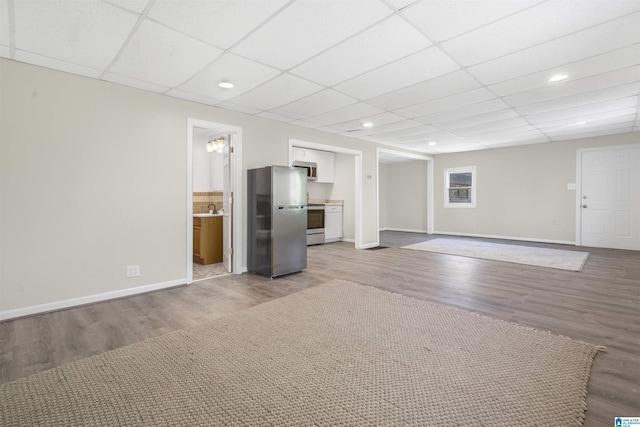 2315 Blackjack Rd, Trussville, AL 35173 - unfurnished living room featuring wood finished floors, baseboards, a sink, and a paneled ceiling