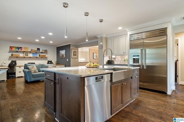 5448 Palomino Trl, Birmingham, AL 35242 - kitchen featuring crown molding, appliances with stainless steel finishes, dark wood-style floors, and an island with sink