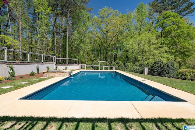 5448 Palomino Trl, Birmingham, AL 35242 - view of swimming pool with a pool with connected hot tub, a view of trees, and fence