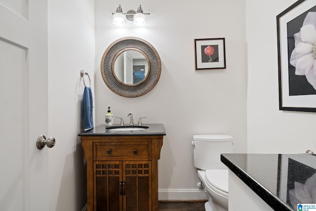 5448 Palomino Trl, Birmingham, AL 35242 - bathroom featuring vanity, baseboards, toilet, and wood finished floors