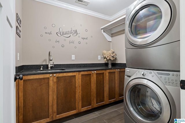 5448 Palomino Trl, Birmingham, AL 35242 - clothes washing area with visible vents, a sink, dark wood-style flooring, stacked washer / drying machine, and crown molding