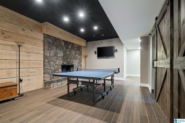 5448 Palomino Trl, Birmingham, AL 35242 - recreation room with baseboards, recessed lighting, a fireplace, a barn door, and wood finished floors