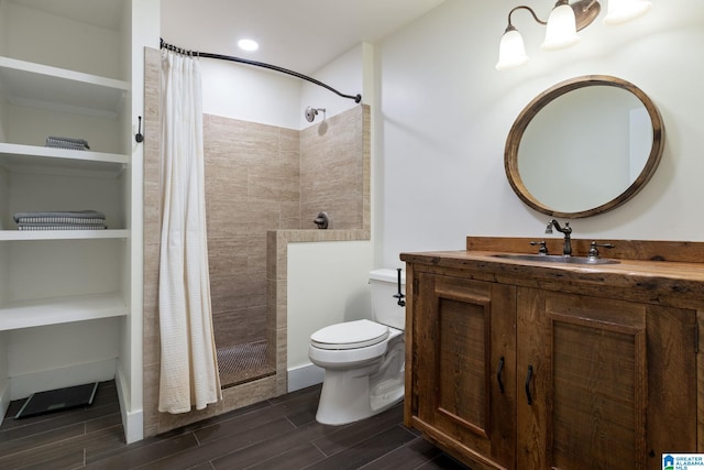 5448 Palomino Trl, Birmingham, AL 35242 - full bathroom with toilet, vanity, a tile shower, and wood finish floors