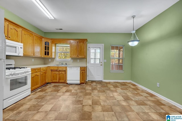 kitchen featuring visible vents, baseboards, light countertops, stone finish floor, and white appliances
