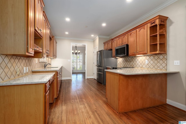 kitchen featuring a chandelier, dark wood-style floors, baseboards, a peninsula, and appliances with stainless steel finishes