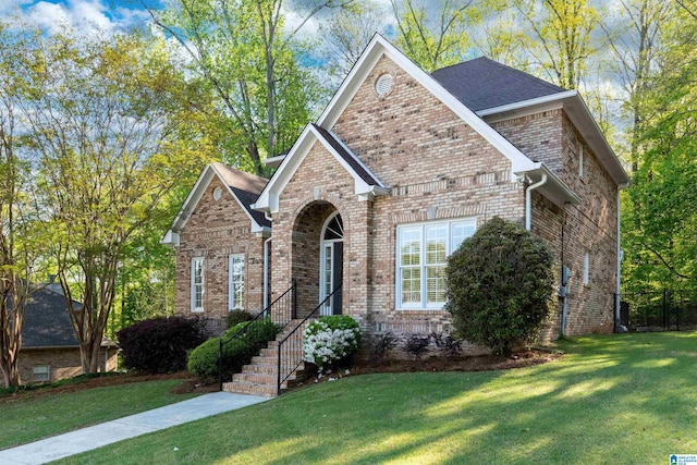 view of front of property featuring a front lawn and brick siding