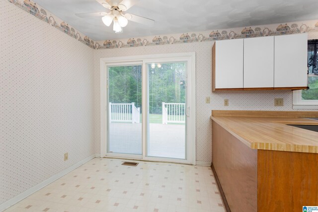 interior space with baseboards, plenty of natural light, and light floors