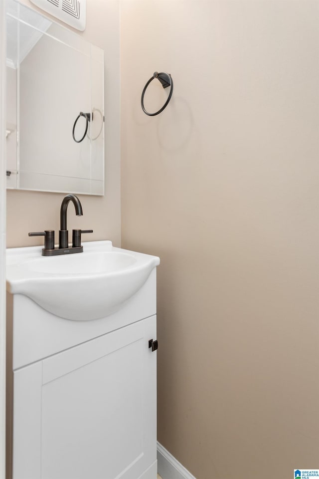 bathroom with vanity, baseboards, and visible vents