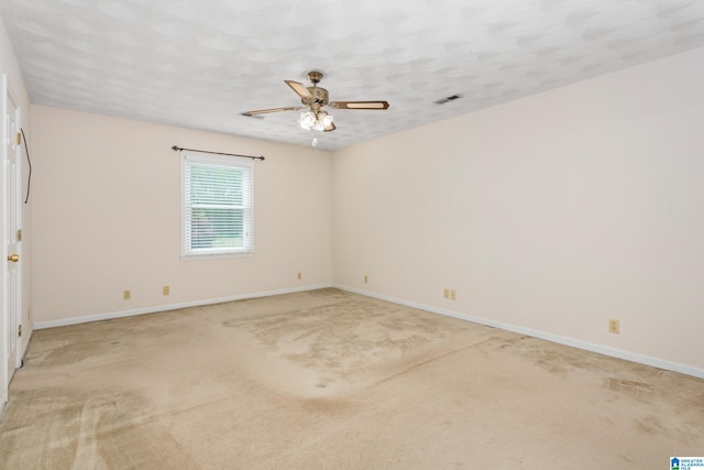 unfurnished room with ceiling fan, baseboards, and light carpet