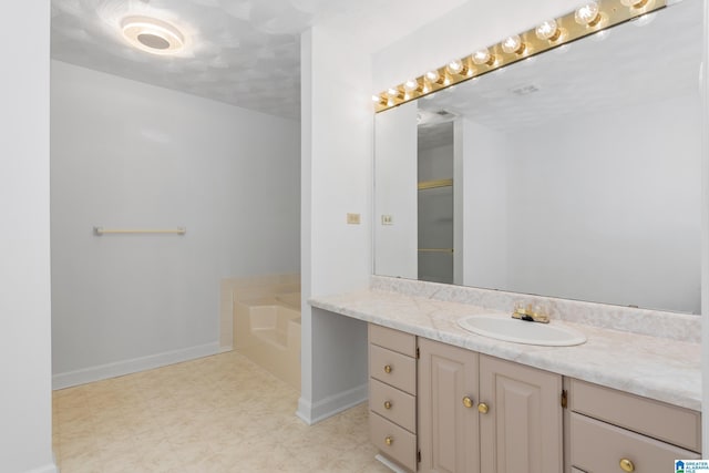 full bath with a bath, vanity, baseboards, and tile patterned floors