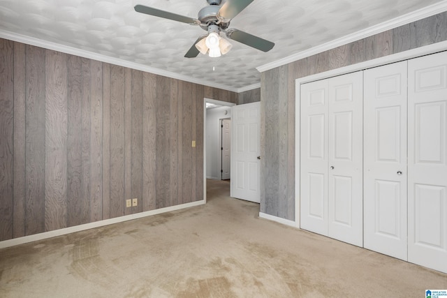 unfurnished bedroom with carpet floors, baseboards, a closet, and ceiling fan